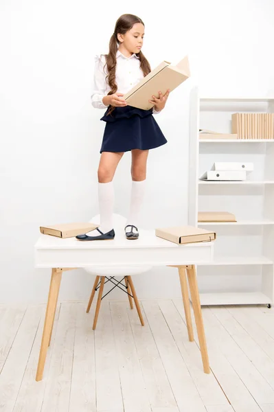 Schoolgirl stand table work archive folder. Cute little bookworm. Pupil studying history read archive document. Search for historical facts. Born to be detective. Schoolgirl find interesting document
