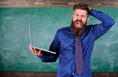 Modern eğitim programı. Öğretmen modern dizüstü kara tahta arka plan ile adam sakallı. Yenilikçi öğretmen laptop ile sürpriz eğitim programı hakkında deli gider. Modern teknoloji fikrini darbeler