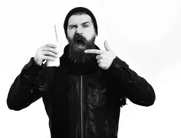 Bearded brutal caucasian hipster holding glass jar of milk — Stock Photo, Image