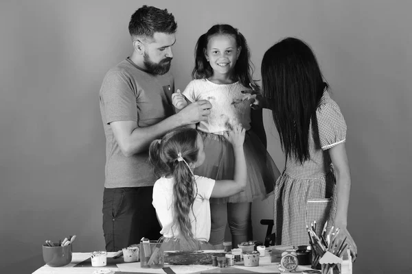 Parents and children paint with gouache on girls top