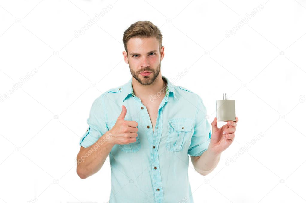 Man confident face recommend perfume shows thumb up gesture. Guy with bristle bottle perfume he likes this fragrance. Male fragrance concept. Man handsome recommend pleasant aroma for male