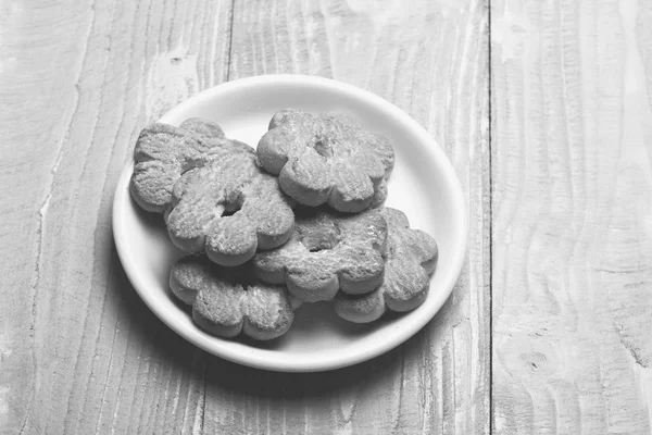 Teekekse auf grauem Holzgrund. Zusammensetzung von winzigen Torten — Stockfoto