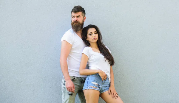 Youth stylish outfit. Couple white shirts cuddle each other. Couple friends hang out grey background copy space. Feel their style. Hipster bearded and stylish girl hang out urban romantic date