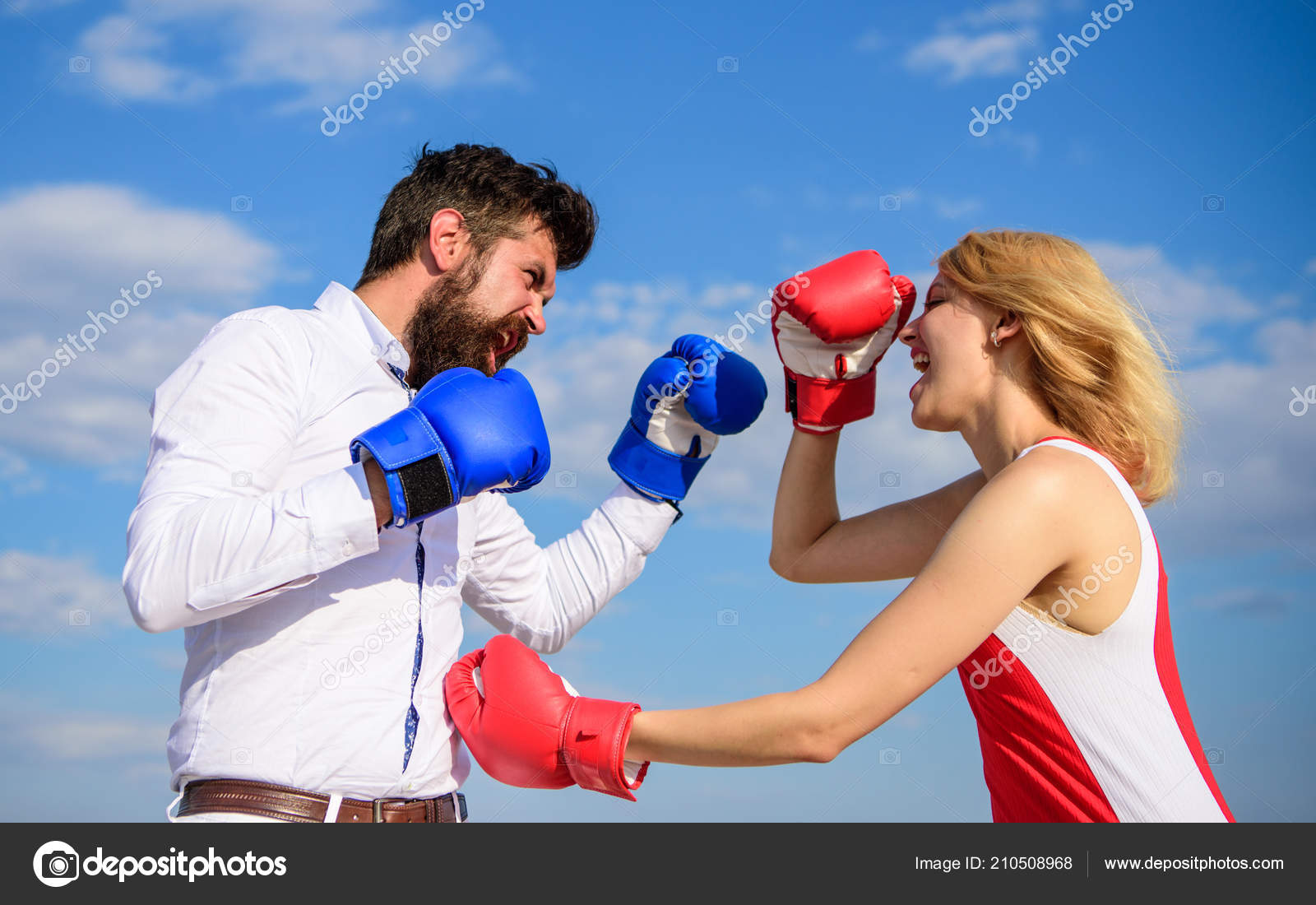 Man and woman fight boxing gloves blue sky background. Defend your opinion in confrontation. Couple in love fighting image
