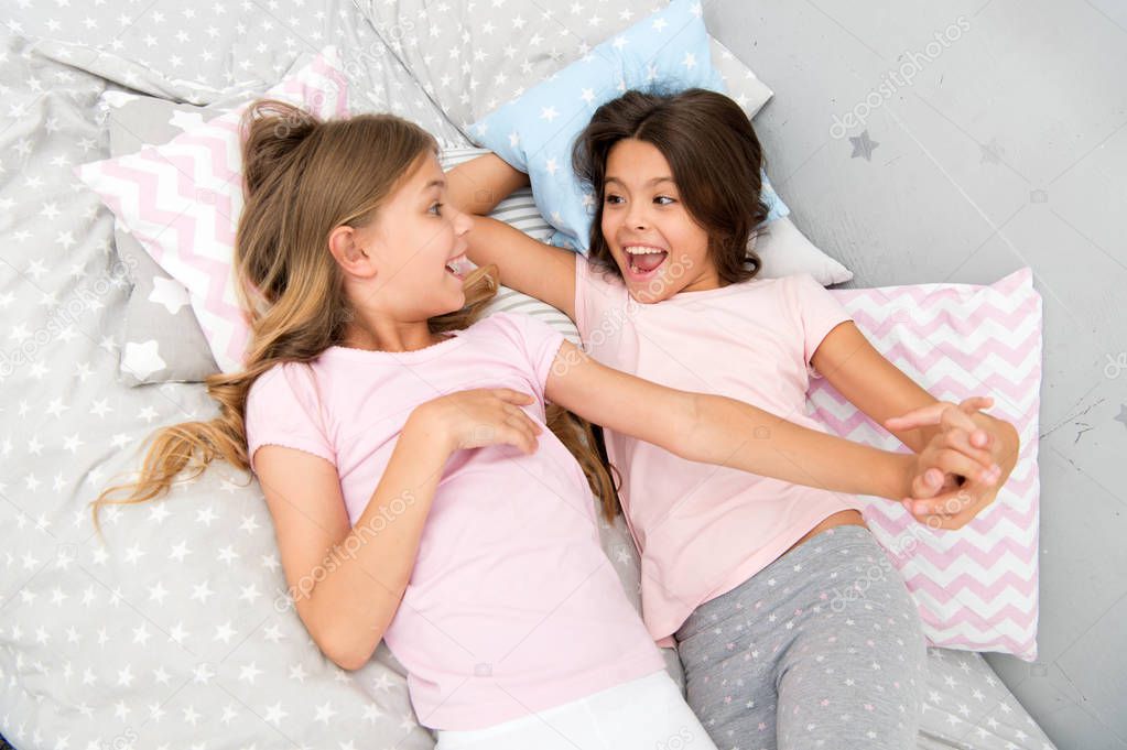 good morning and healthy sleep. little girls say good morning to each other. little girls in bed after healthy sleep.