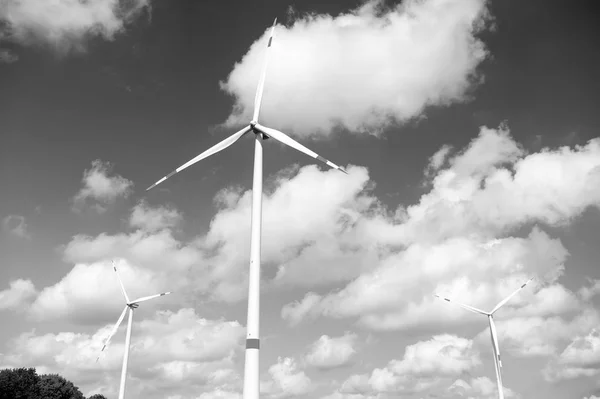 Wind turbine on cloudy blue sky. Alternative energy and electricity source. Global warming. climate change and ecology. Eco power and green technology concept — Stock Photo, Image