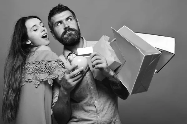Money and shopping concept. Guy with beard and lady