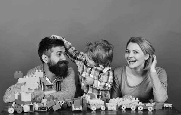 Man with beard, woman and boy play on red background