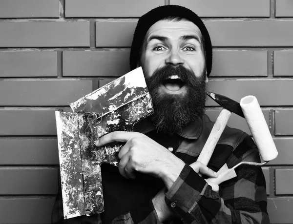 Bearded builder man holding various building tools with happy face — Stock Photo, Image