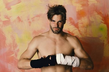 Kendine güvenen yüzü ve renkli arka planda çıplak gövdesi olan bir adam.