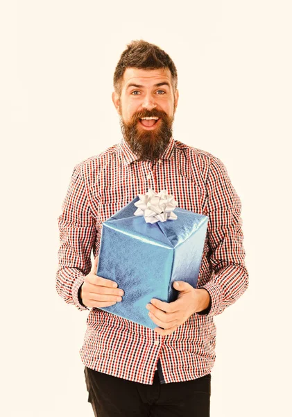 Macho with wrapped blue gift and white bow. — Stock Photo, Image