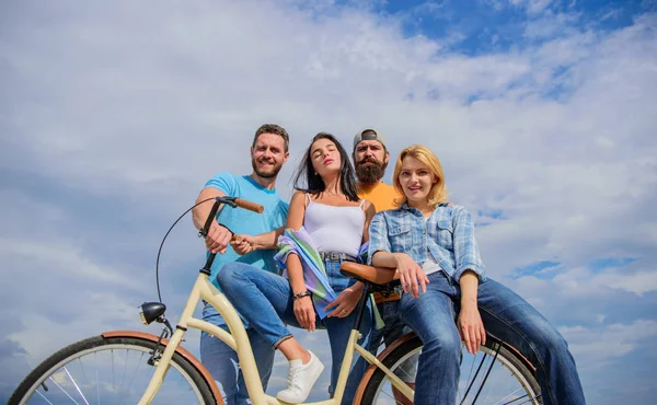 Share or rental bike service. Cycling modernity and national culture. Company stylish young people spend leisure outdoors sky background. Group friends hang out with bicycle. Bicycle as best friend