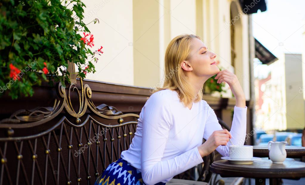 Pleasant thoughts. Enjoy her life. Woman blonde dreamy smiling face enjoy having coffee, urban background defocused. What do girls dream about. Lady happy dreaming while enjoy relaxing cafe terrace