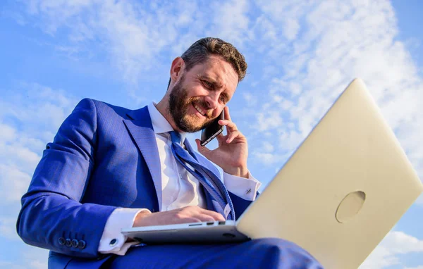 Sales manager responsibilities. Man formal suit work with laptop while speak on phone. Ultimate guide to becoming sales leader. Businessman surfing internet while speaking to client. Stay in touch