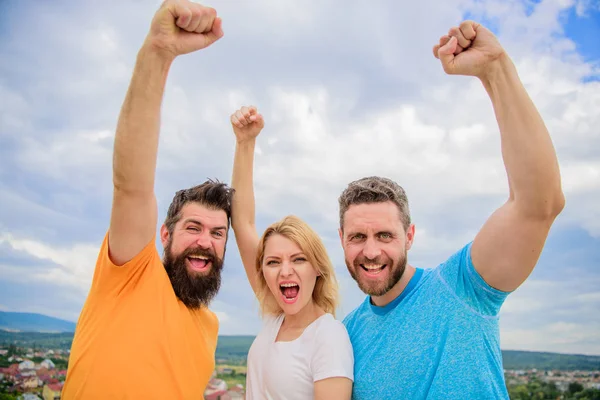 Woman and men look confident successful sky background. Threesome stand happy confidently with raised fists. Behaviors of cohesive team. Celebrate success. Yes we can. Ways to build ohesive team — Stock Photo, Image