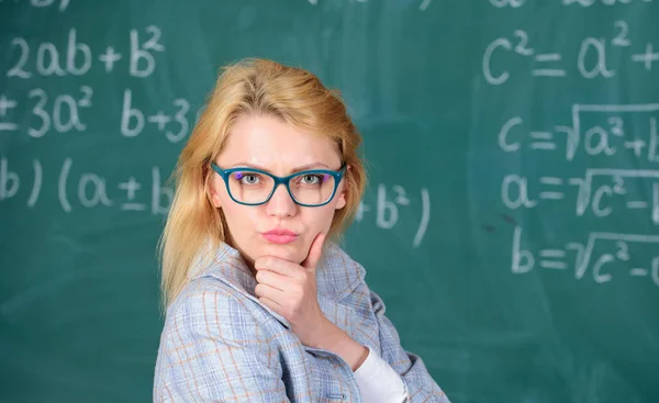 Solve mathematics task. Teacher woman think about solving and result. Lady wear eyeglasses smart teacher classroom chalkboard background, close up. Solve that task. School education basic knowledge — Stock Photo, Image