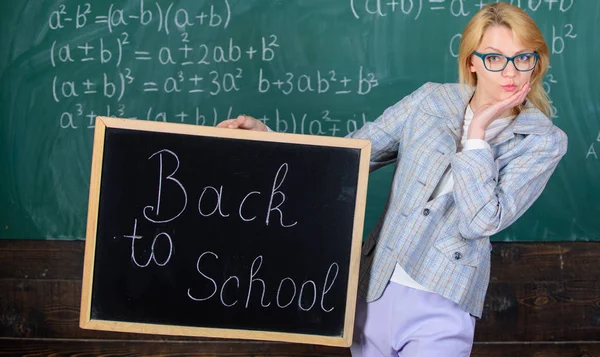 Are you ready to study. Beginning of new school season. Woman teacher holds blackboard inscription back to school. Lady educator in classroom wonders you ready to study. Teacher welcomes school year — Stock Photo, Image