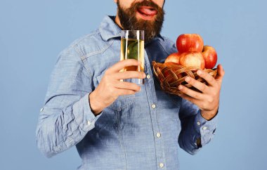 Sakallı adam meyve suyu dolu bir kase tutuyor.