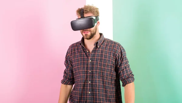 Man unshaven guy virtual reality glasses, pink background. Hipster use modern technology virtual reality. Guy head mounted display work 3d space. Vr technology gives new opportunities in engineering