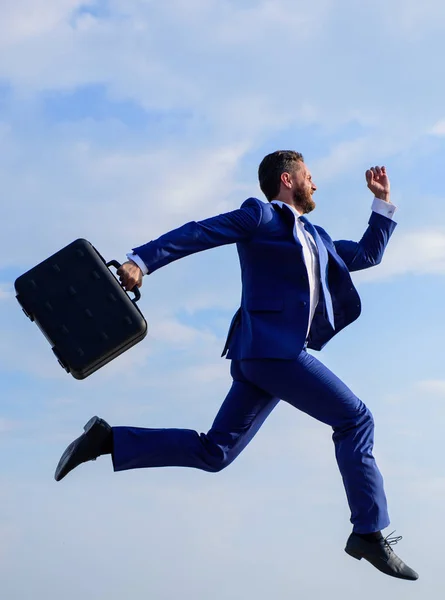 Businessman formal suit make effort to succeed. Success in business demands supernatural efforts from entrepreneur personality. Businessman with briefcase jump high motion forward. Supernatural power