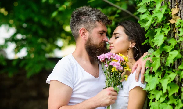 stock image Gentle kiss. Man bearded hipster hugs gorgeous girlfriend. Pleasant romantic kiss. Couple love romantic date nature park background. Love relations romantic feelings. Couple in love going to kiss