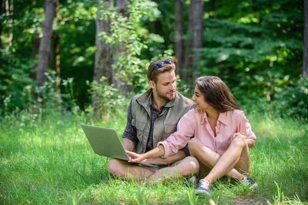 Man and girl looking at laptop screen. Freelance opportunity. Modern technologies give opportunity to be online and work in any environment conditions. Couple youth spend leisure outdoors with laptop