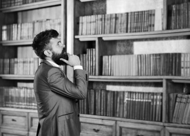 Seçim ve karar kavramı. Adam seçim ayakta kitaplığında yapar.