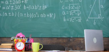 Öğretmenler öznitelikleri. Aday öğretmenler göz önünde bulundurmanız gereken çalışma koşulları. Geleneksel öğretmenler işyeri. Tablo okul ile çalar saat kitap ve kupa sınıf kara tahta arka plan sağlar.