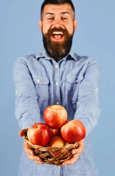 Guy presents homegrown harvest. Gardening and fall crops concept. Man with beard