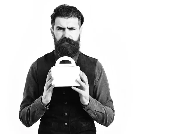 Bearded man holding lunch box with serious face — Stock Photo, Image