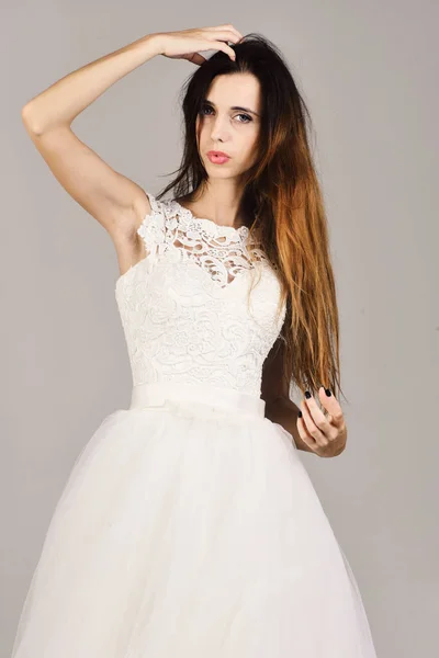 Wedding and special day concept. Girl with serious face wears white wedding dress