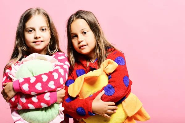 Girls with loose hair hug pillows. Party time concept — Stock Photo, Image