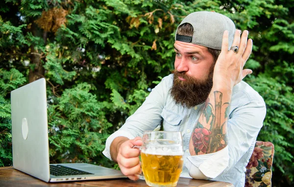 Disappointed with game result. Brutal man leisure with beer and sport game. Football fan bearded hipster watch game on laptop screen. Fan watch stream online while sit terrace outdoors drink beer