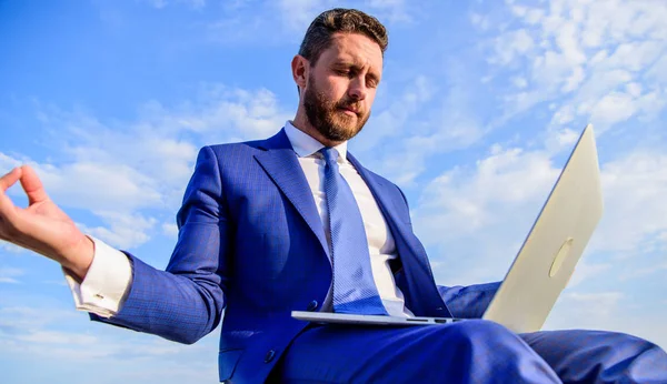Businessman formal suit with laptop meditating outdoors. Man try keep his mind clear. Entrepreneur find minute relax and meditate. Work online can be annoying. Communication online full of bullying