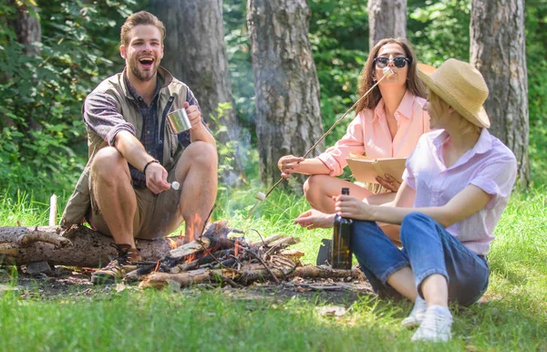Hikers traditions. Spend great time on weekend. Take a break to have snack. Company friends prepare roasted marshmallows snack nature background. Company hikers at picnic roasting marshmallows snacks