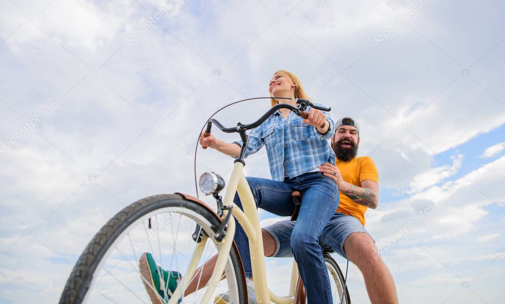 Enjoy summer holidays vacation riding bike. Couple in love happy cheerful enjoy cycling together. Happy moments. Active leisure tips. Summer holidays ideas. Youth have fun riding bike sky background