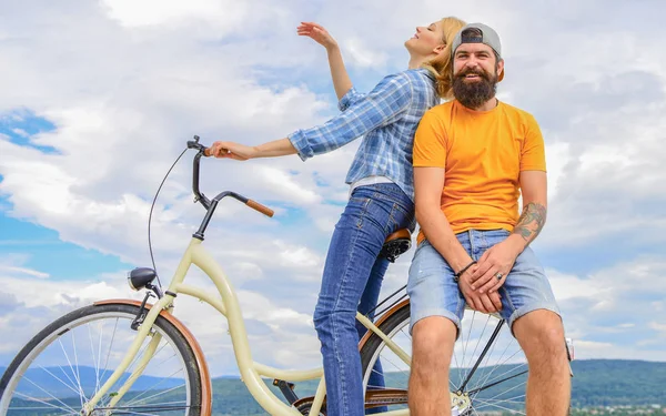 Bike rental or bike hire for short periods of time. Date ideas. Couple with bicycle romantic date sky background. Man and woman spend active leisure with bike. Couple in love date outdoors cycling