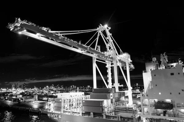 Miami, USA - November, 23, 2015: freight, shipping, delivery, logistics, merchandise. Maritime container port with cargo containers, cranes at night. Port or terminal with night illumination — Stock Photo, Image