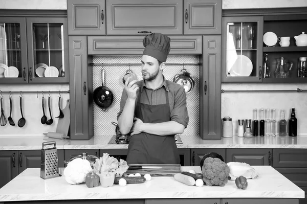 Man in chef hat, apron cook in kitchen