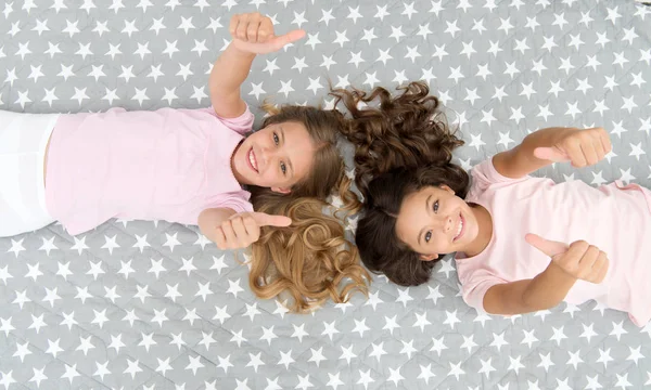 Çocuklar iyi niyet göstergesi. Kız çocukları yatak manzarasında. Pijama partisi konsepti. Kızlar sadece eğlenmek ister. Kız sırları dürüst ve samimi. Arkadaşlar iyi vakit geçirir. — Stok fotoğraf