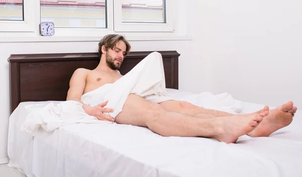 Morning wood or formally known nocturnal penile tumescence common occurrence for man. Male health. Normal erections occur. Macho sexy guy torso relaxing lay bedroom. Why men get morning erections