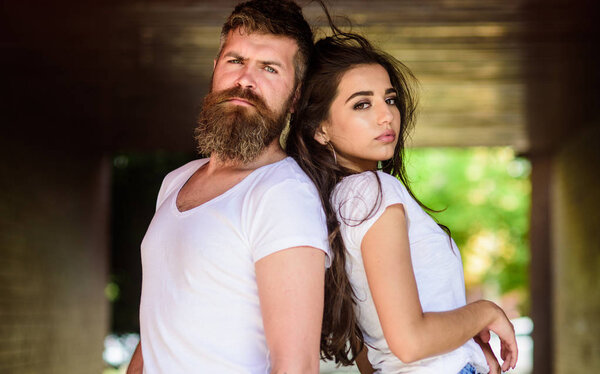 Girl attractive brunette bearded hipster man stand back to back porch underground crossing. Couple problems relationship. Couple has disagreements. Couple in love can not find same point of view