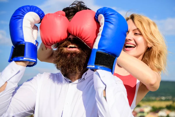 Tricky female. Cunning tricks to win. Relations game or struggle. Play and have fun. Tricks every woman needs to know. Girl smiling face covers male face with boxing gloves. Break rules to success — Stock Photo, Image