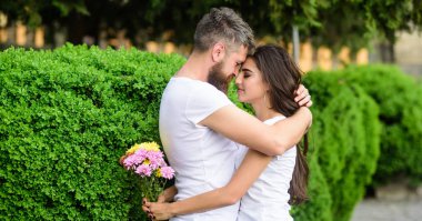 Aşık çift içinde park yeşil çalılar geçmiş tarihte sarılmak. Adam aşık güzel bir kız. Adam hipster hugs kadın sakallı. Güçlü romantik hisler gerçek aşk haline. Gitmesine asla izin vermeyeceğim