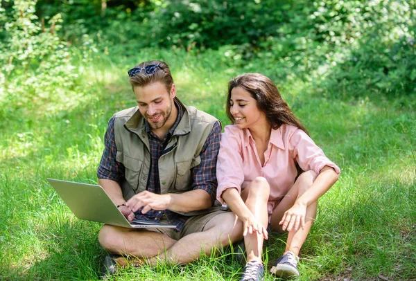 Nature best workspace. Couple youth spend leisure outdoors with laptop. Modern technologies give opportunity to be online and work in any environment conditions. Man and girl looking at laptop screen