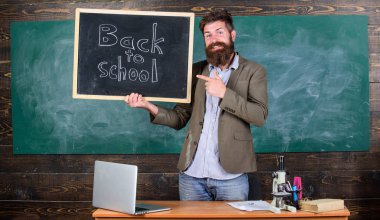 Sakallı adam blackboard yazıt okula geri tutar. Öğretmenler yeni öğretim yılı için işe. Seyir öğretmen tamamlayıcı nitelikli işgücü eğitimciler etti. Geri okul öğretmenler işe alım