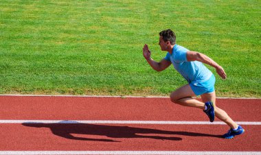 Kesintisiz hareket hayat. Stadyum yeşil çim arka atlet. Sportif şekil hareket. Spor yaşam tarzı ve sağlık kavramı. Adam atlet büyük sonucu elde etmek için çalıştırın. Dürtü taşımak için