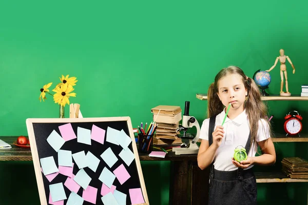 Παιδική ηλικία και μελέτη έννοια του χρόνου. Κορίτσι κρατά πράσινο ρολόι — Φωτογραφία Αρχείου