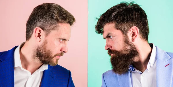 Business competition and confrontation. Business partners competitors or office colleagues in suits with tense bearded faces close up. Hostile or argumentative situation between opposing colleagues — Stock Photo, Image