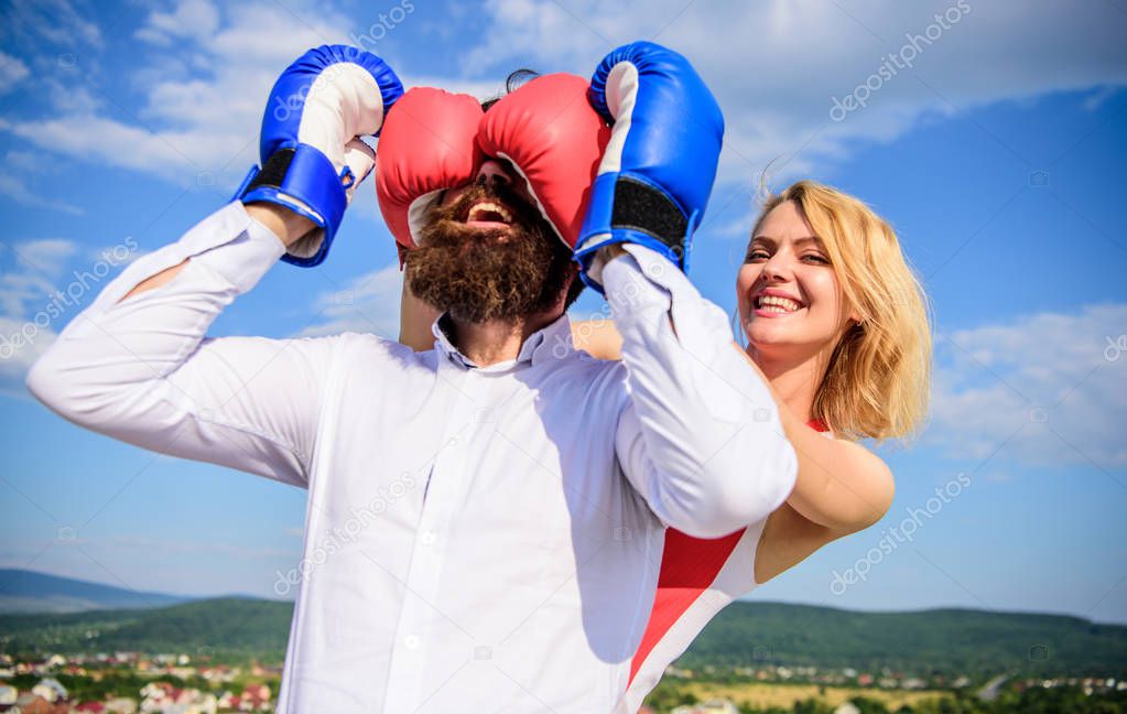 Tricky female. Relations game or struggle. Play and have fun. Tricks every woman needs to know. Girl smiling face covers male face boxing gloves. Break rules success. Dexterous tricks play relations